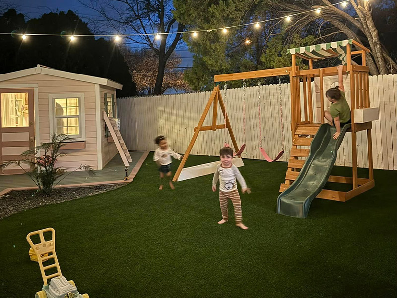 backyard with new turf and kids playing