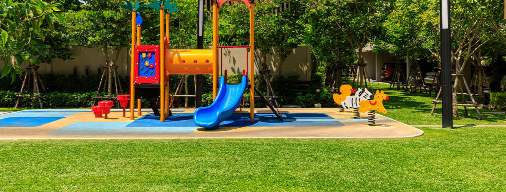 playground with blue slide and rocking horses