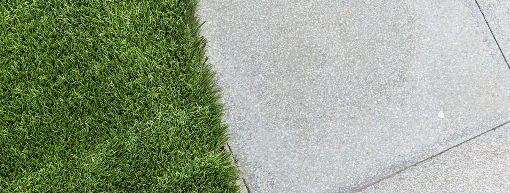 concrete sidewalk next to grass