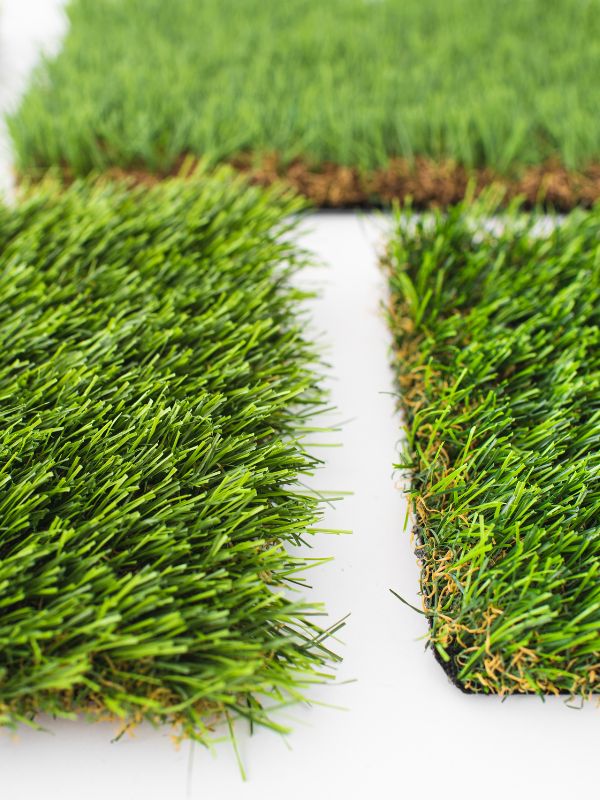 Artificial turf strips are installed in a residential yard. 
