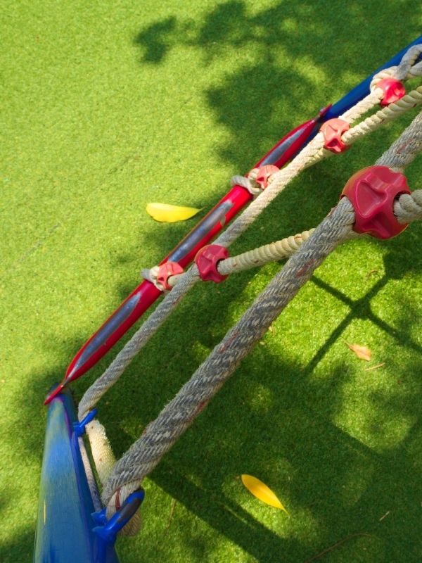 Playground equipment ontop of beautifully installed artificial playground turf. 